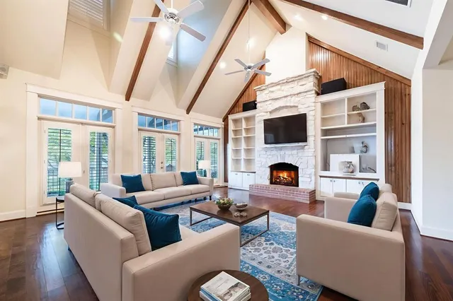 a living room with furniture a fireplace and a flat screen tv