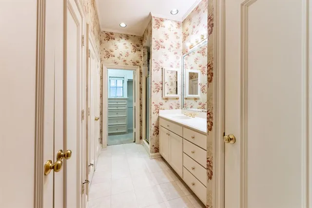 a spacious bathroom with a bathtub sink and mirror