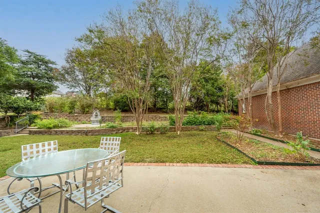 a view of a house with backyard and sitting area
