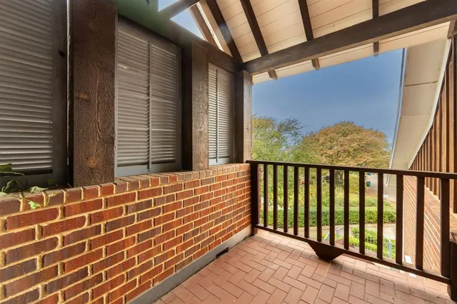 a view of a house with a large tree and a yard