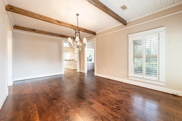 a view of an empty room with glass door and a window