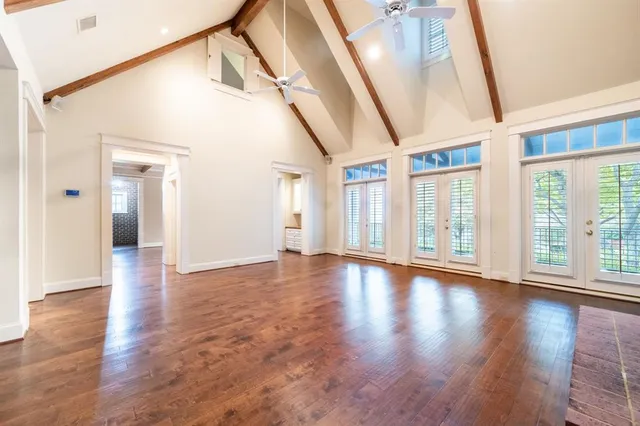 a kitchen with granite countertop stainless steel appliances white cabinets and a window