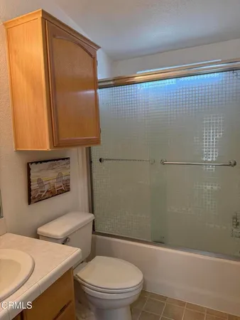 a bathroom with a toilet a sink and shower