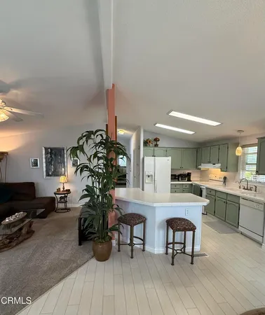 a kitchen with counter top space and wooden floor