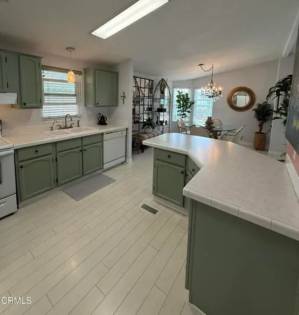a kitchen with a sink and a stove top oven