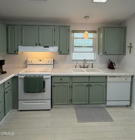 a kitchen with a sink stove and cabinets