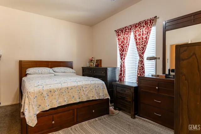 a bedroom with a bed and a dresser