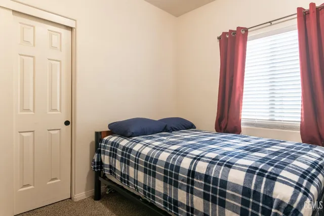 a bathroom with a granite countertop toilet and a sink