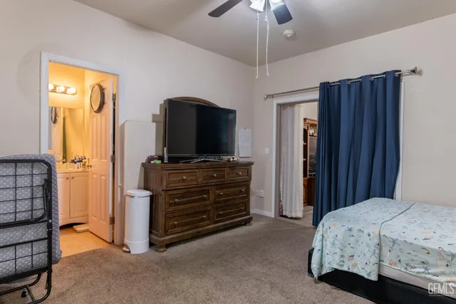 a bathroom with a sink toilet vanity and shower