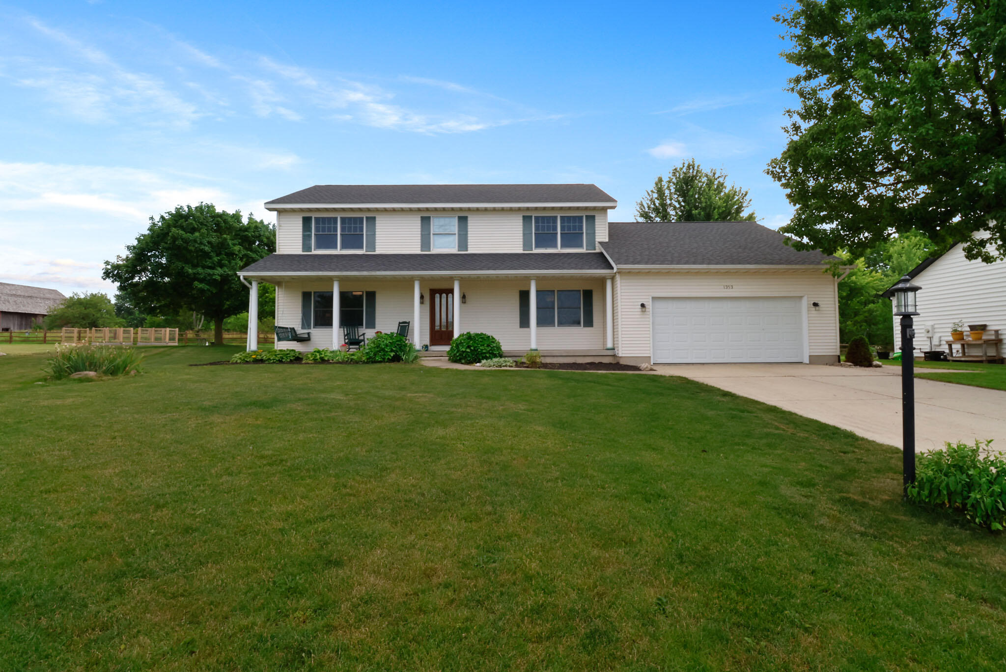 1353 Cobblestone Drive Valparaiso, IN 46385 - Photo 1 of 35 a front view of a house with a yard and trees