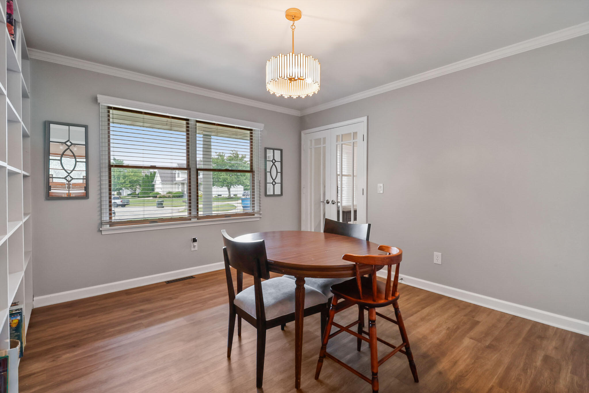 1353 Cobblestone Drive Valparaiso, IN 46385 - Photo 14 of 35 a dining room with chandelier and wooden floor