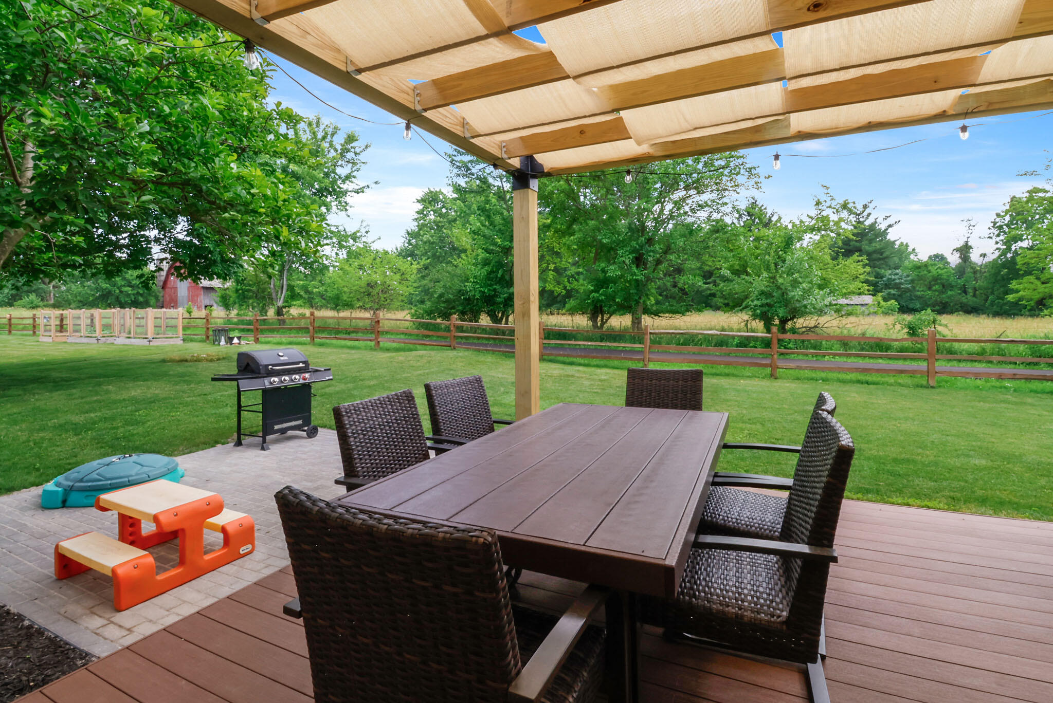 1353 Cobblestone Drive Valparaiso, IN 46385 - Photo 33 of 35 a view of a patio with a table chairs and a backyard