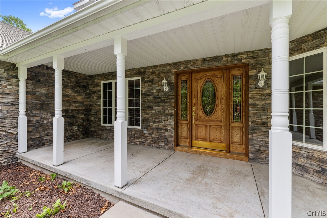 1103 Rail Fence Road Camillus, NY 13031 - Photo 6 of 50 The inviting front porch welcomes you home and is the perfect place to unwind. Imagine relaxing in your rocking chairs with a morning cup of coffee, getting lost in a good book, or ending the day with a glass of wine while taking in the peaceful surroundings.