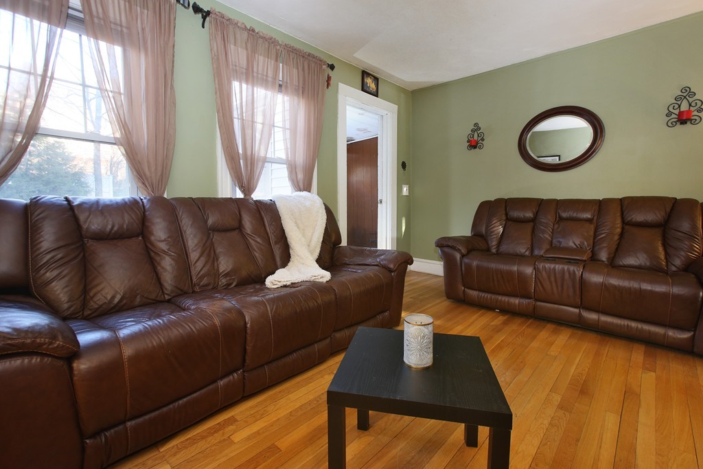 130 Lancaster Terrace Brookline, MA 02446 - Photo 2 of 6 a living room with furniture and a large window