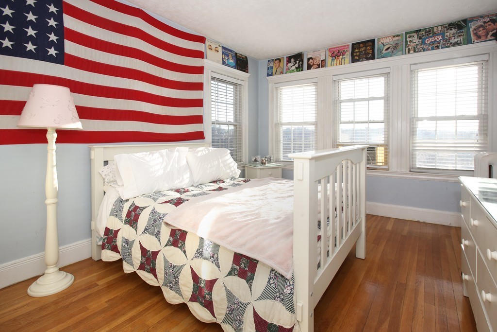 130 Lancaster Terrace Brookline, MA 02446 - Photo 5 of 6 a bedroom with a bed and wooden floor