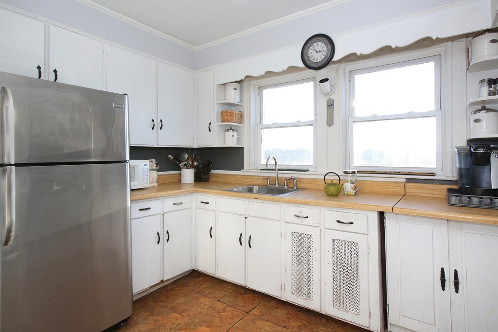130 Lancaster Terrace Brookline, MA 02446 - Photo 6 of 6 a kitchen with granite countertop a sink cabinets and window