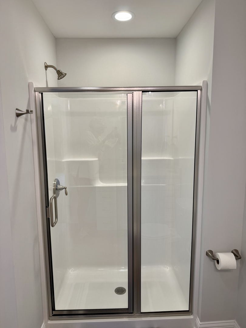 2222 Maggie Lane Sycamore, IL 60178 - Photo 15 of 24 a bathroom with a glass shower door