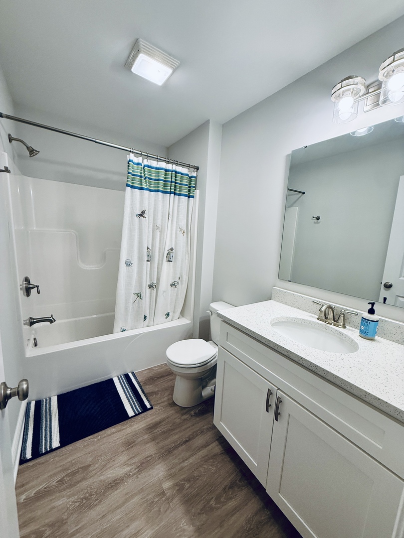 2222 Maggie Lane Sycamore, IL 60178 - Photo 20 of 24 a bathroom with a granite countertop sink toilet a large mirror a shower and a bathtub