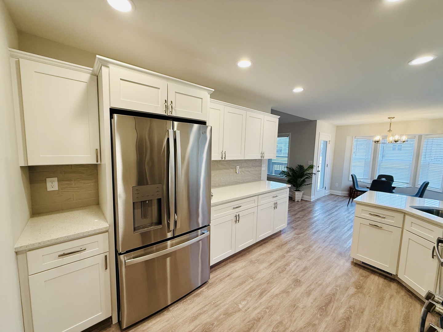 2222 Maggie Lane Sycamore, IL 60178 - Photo 8 of 24 a large kitchen with a refrigerator a sink and white cabinets