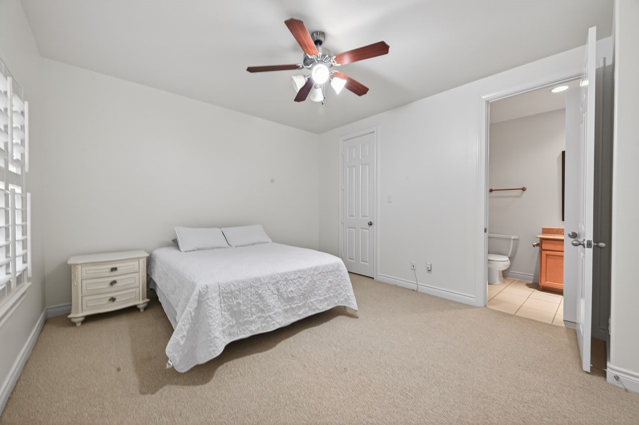 10932 Lasso Lane Houston, TX 77079 - Photo 25 of 38 a bed room with a bed and a ceiling fan