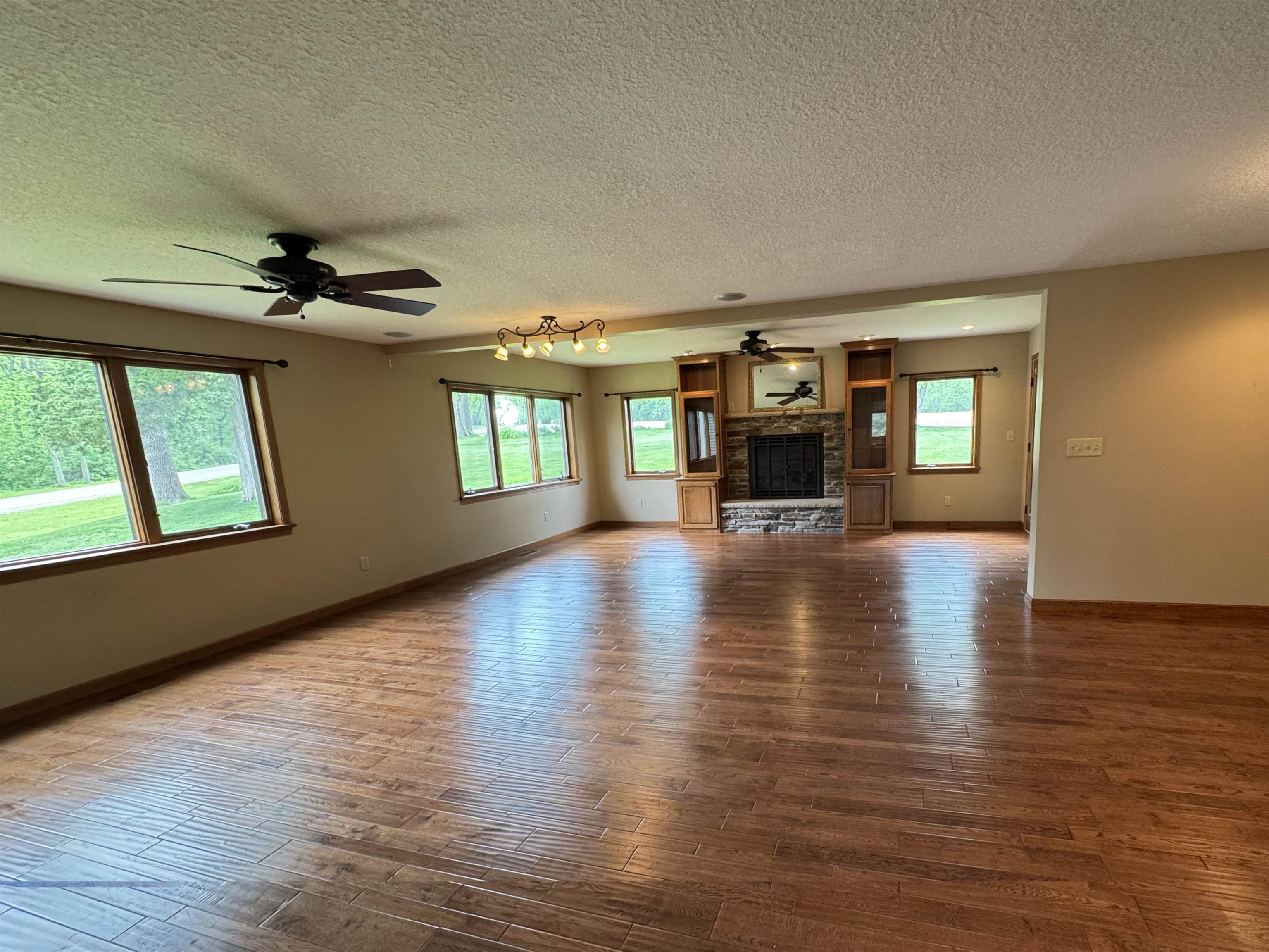 25303 Spring Valley Road Shannon, IL 61078 - Photo 13 of 22 wooden floor in an empty room with a window