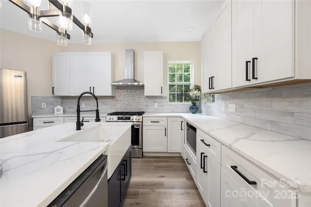 a kitchen with a sink stove and cabinets
