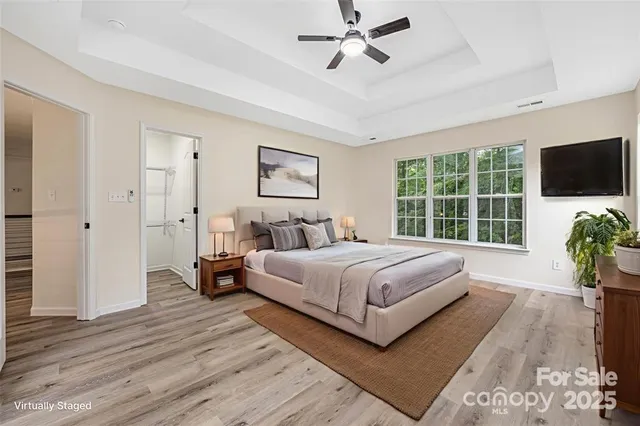 a bedroom with a large bed and a flat screen tv