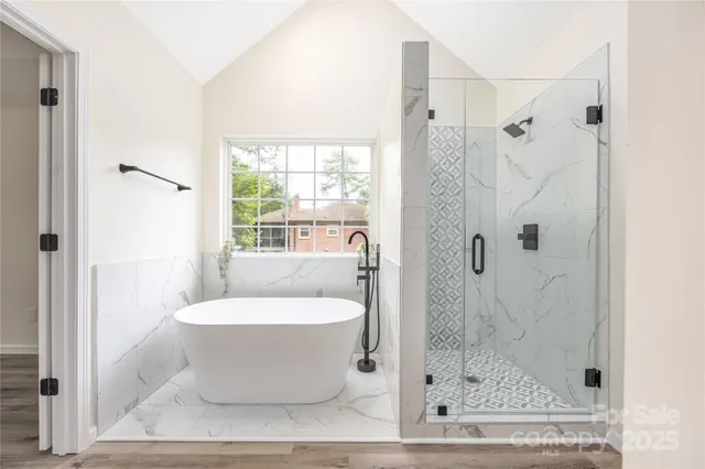a bathroom with a bathtub and shower
