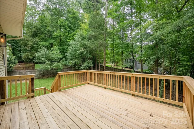 a balcony with wooden floor and trees