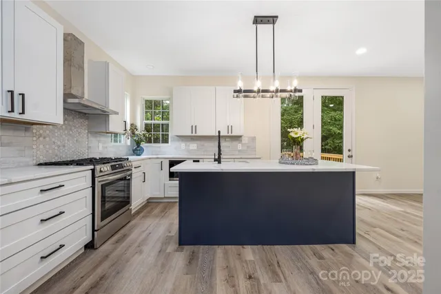 a kitchen with a sink a window and cabinets