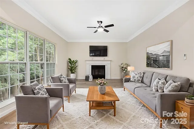 a living room with furniture a fireplace and a flat screen tv