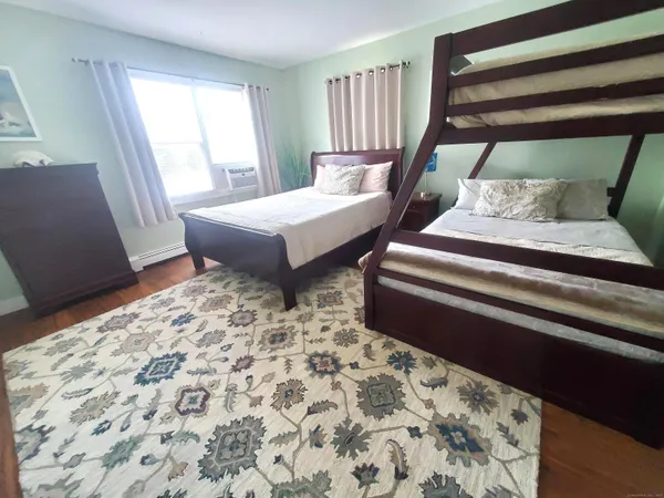 a bedroom with furniture and a window