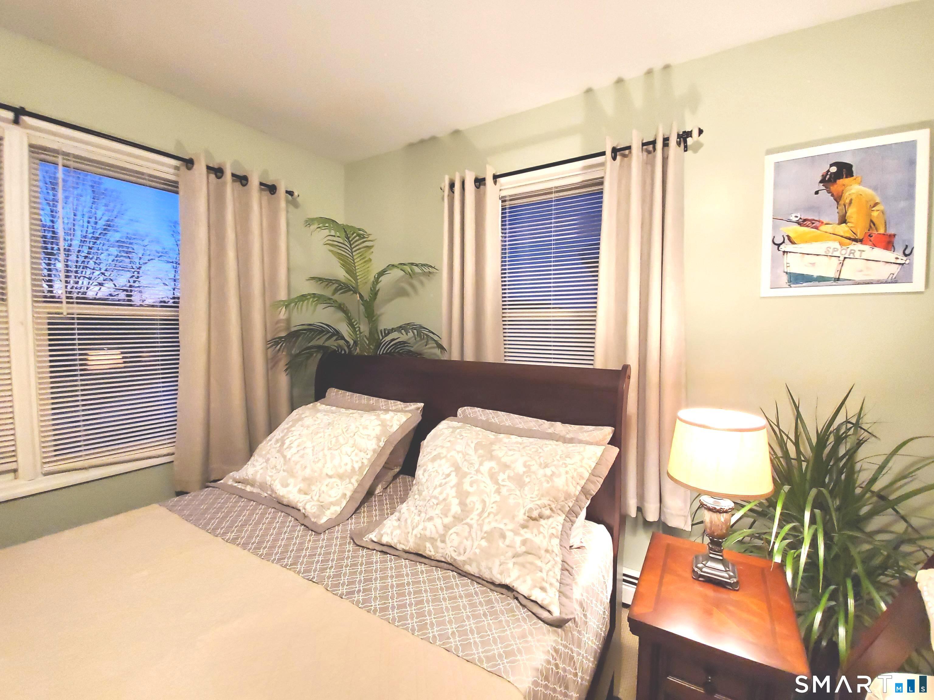 39 Nash Place, Unit A Norwalk, CT 06854 - Photo 16 of 29 a bedroom with a bed and a painting on the wall