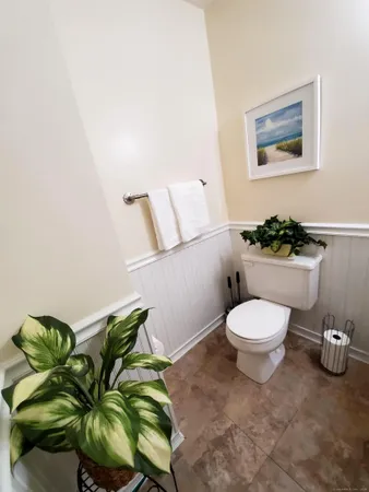 a bathroom with a toilet and a mirror