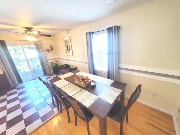 a view of a dining room with a table and chairs