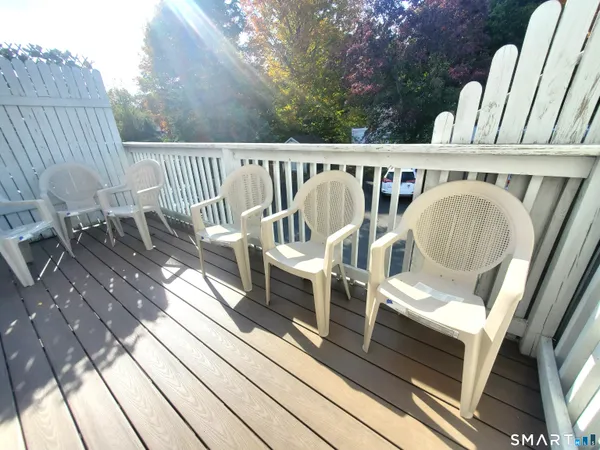 a view of a chairs and table on the balcony