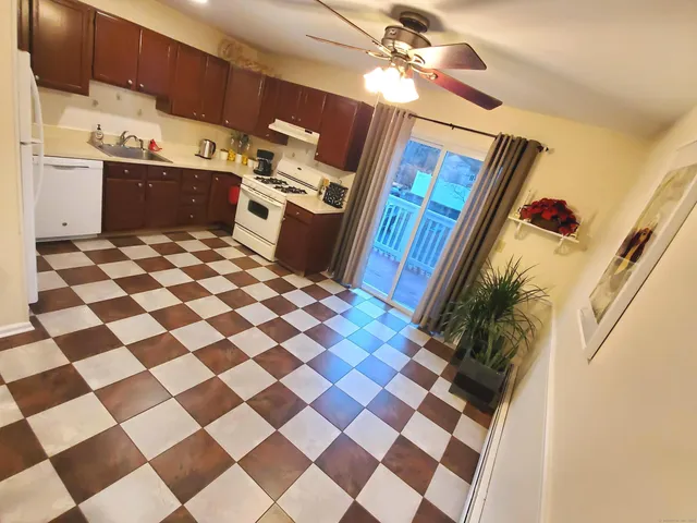 a kitchen with stainless steel appliances granite countertop a black and white cabinets