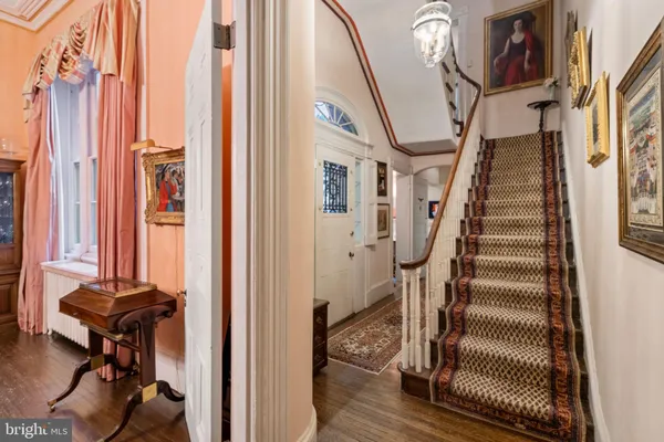 a view of a hallway with wooden floor and entryway