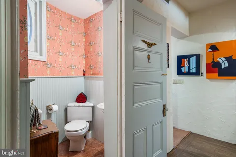 a bathroom with a toilet and a window