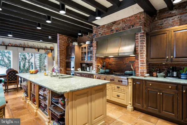 a kitchen with a stove a sink and cabinets