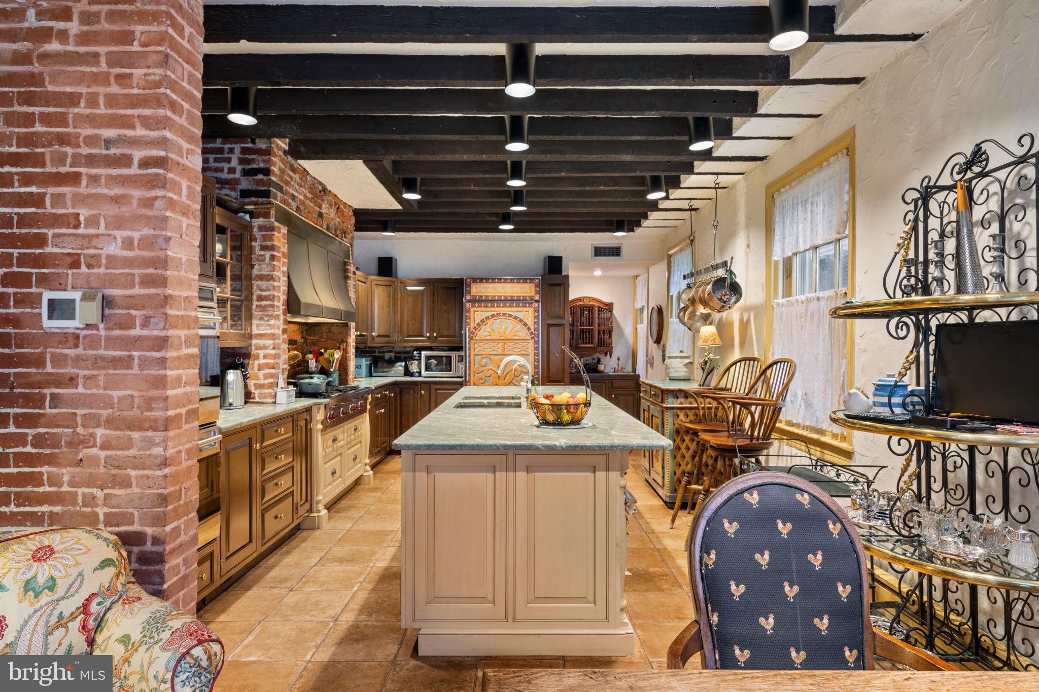 1017 Clinton Street Philadelphia, PA 19107 - Photo 14 of 38 a kitchen with stainless steel appliances granite countertop a stove a sink and a microwave