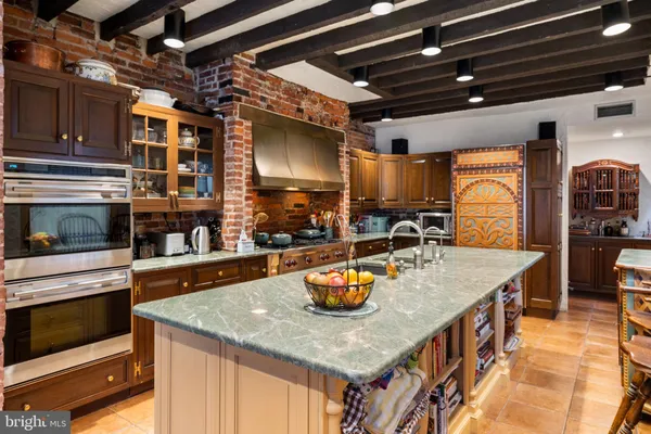 a kitchen with stainless steel appliances granite countertop a sink a stove and a microwave