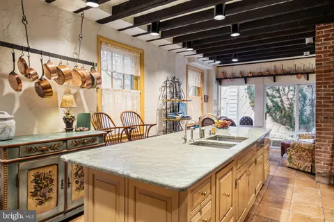 a kitchen with sink stove and cabinets