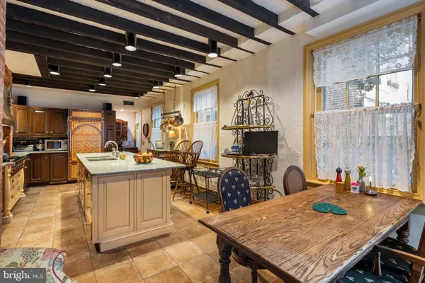 a kitchen with sink and wooden floor