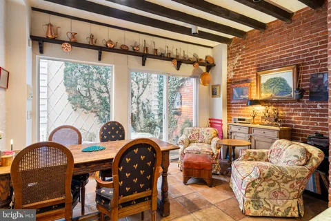 a living room with furniture a window and a fireplace