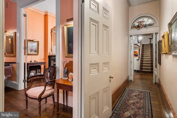 a view of a hallway with furniture and a fireplace