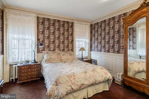 a bed sitting in a bedroom next to a window