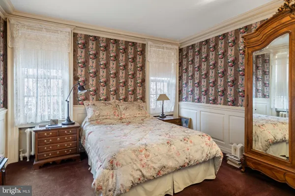 a bed sitting in a bedroom next to a window