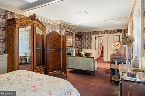 a bedroom with a bed and a mirror