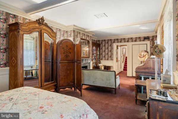 a bedroom with a bed and a mirror